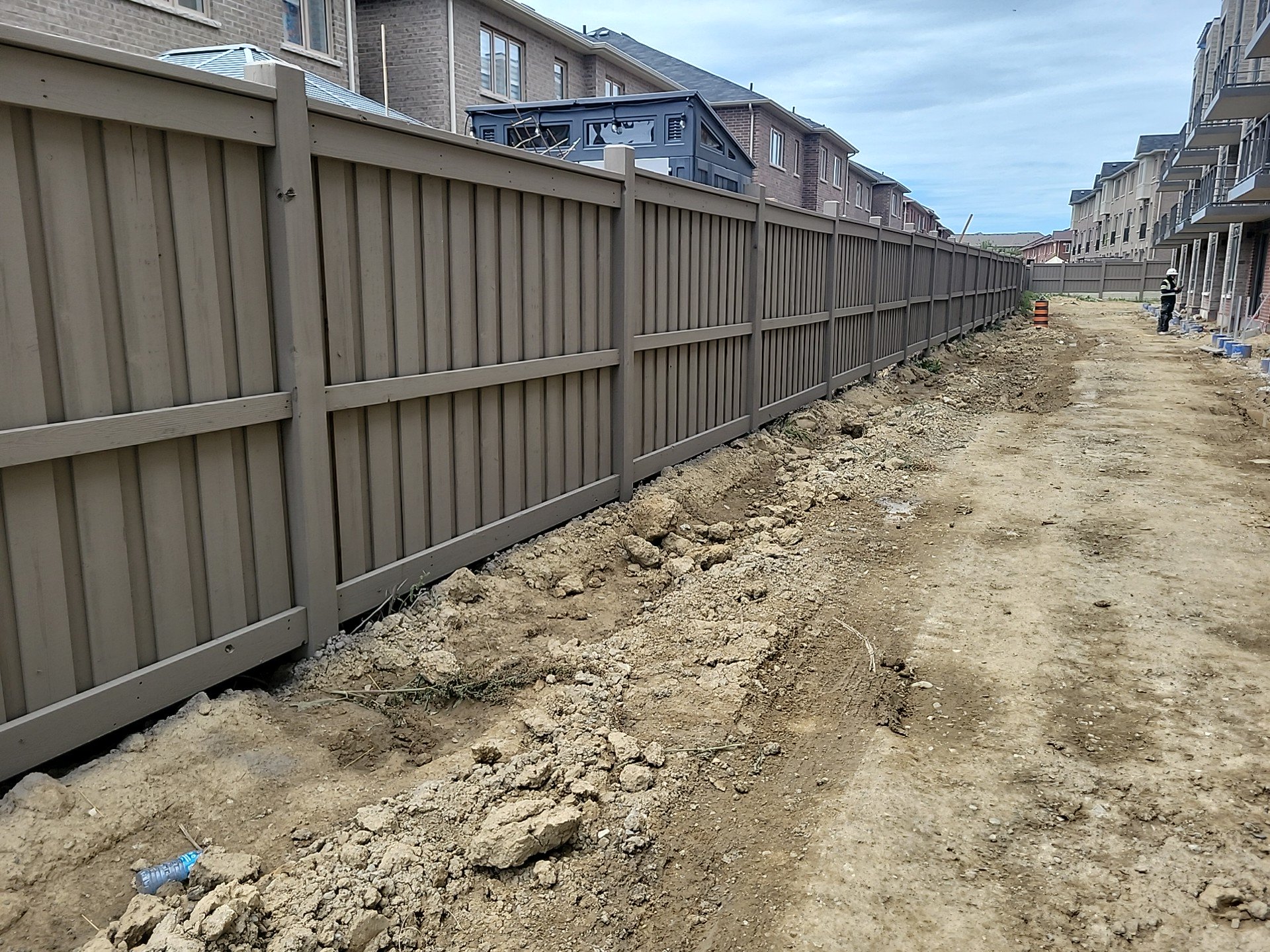 Commercial fence painting Brampton Ontario - large scale subdivision project