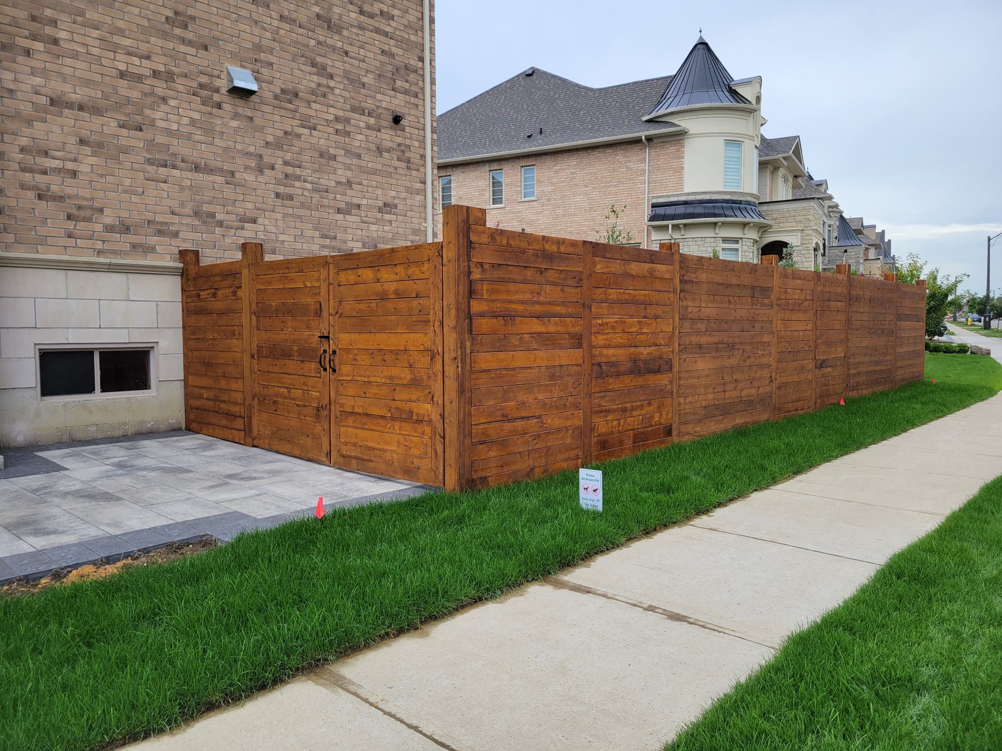 Fence staining Vaughan Ontario - rich brown horizontal wood fence residential